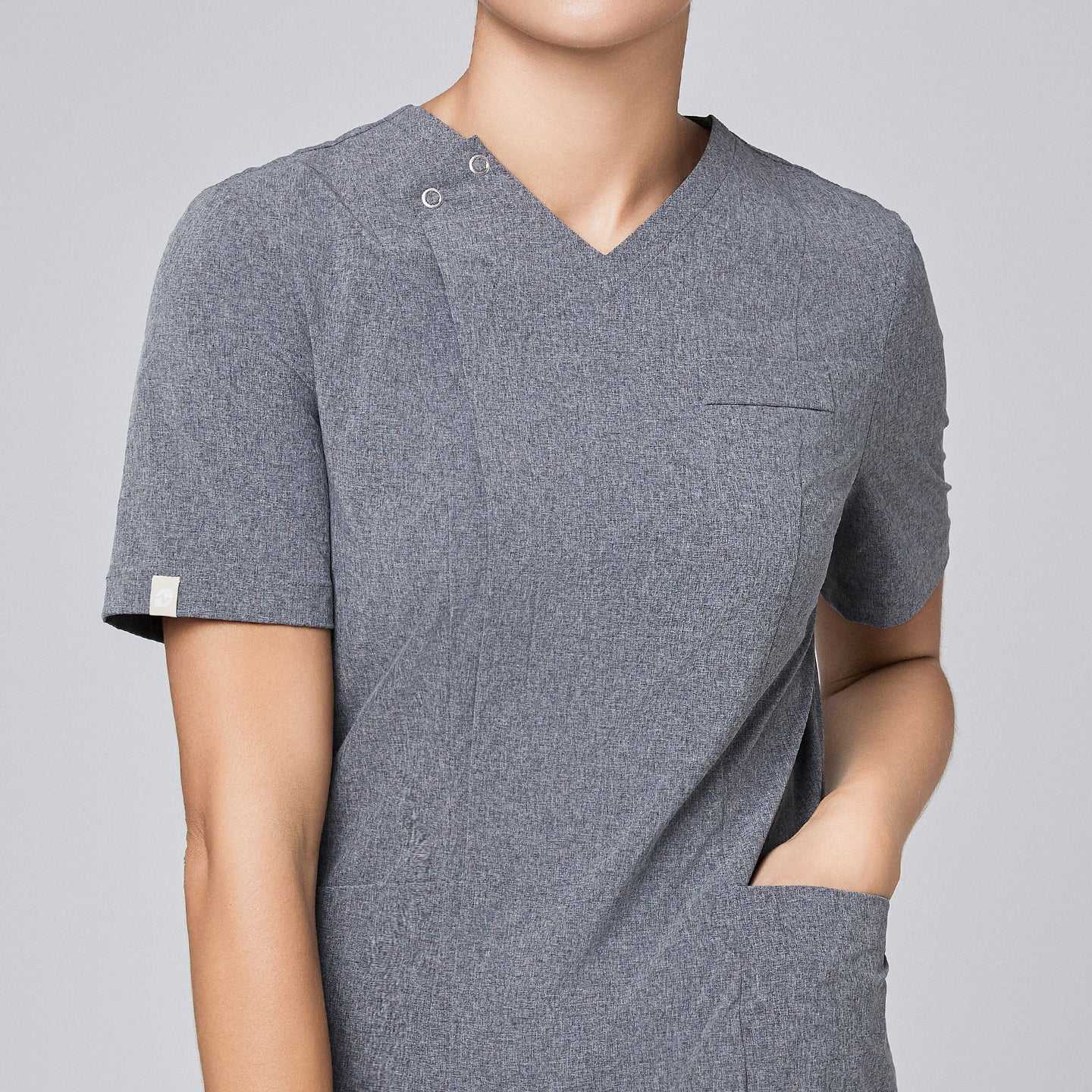 Image of Close-up of Zenir soft gray front zipper scrub top, highlighting the zipper detail and chest pocket,Ash Gray