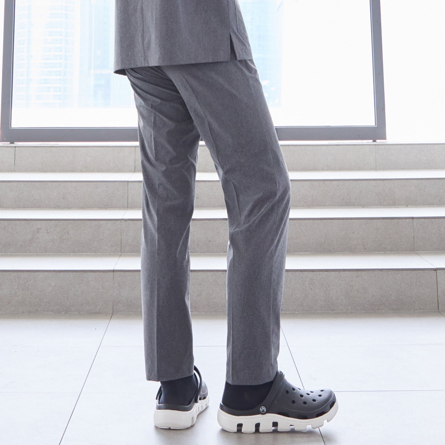 Image of Close-up of man wearing straight-leg scrub pants, standing on stairs indoors,Ash Gray