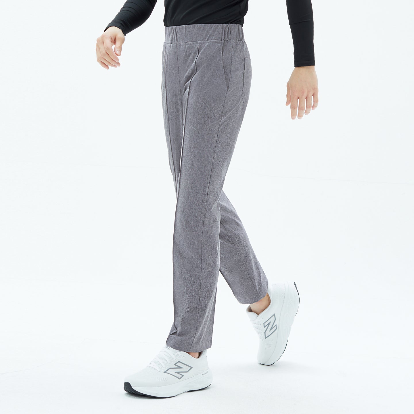 Male model wearing Soft Gray Men’s Line Banding Pants, shown in a half-side walking pose paired with white sneakers.