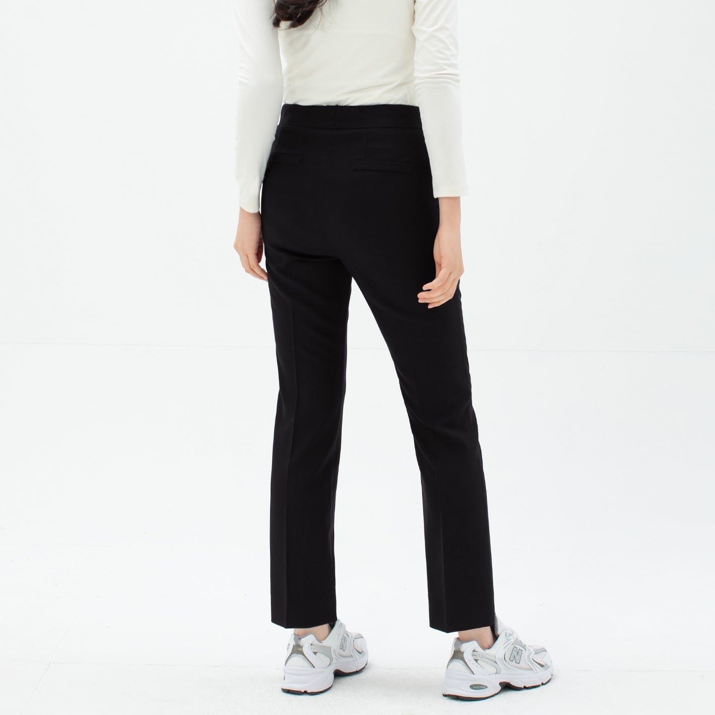Back view of TUL Women's Comfort Banding Pants in Stretch Black, featuring two rear pockets and a clean, modern design.