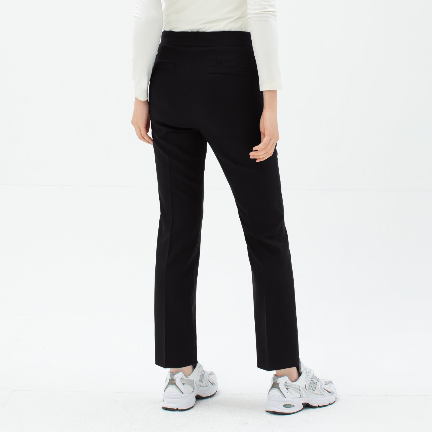 Image of Back view of TUL Women's Comfort Banding Pants in Stretch Black, featuring two rear pockets and a clean, modern design.