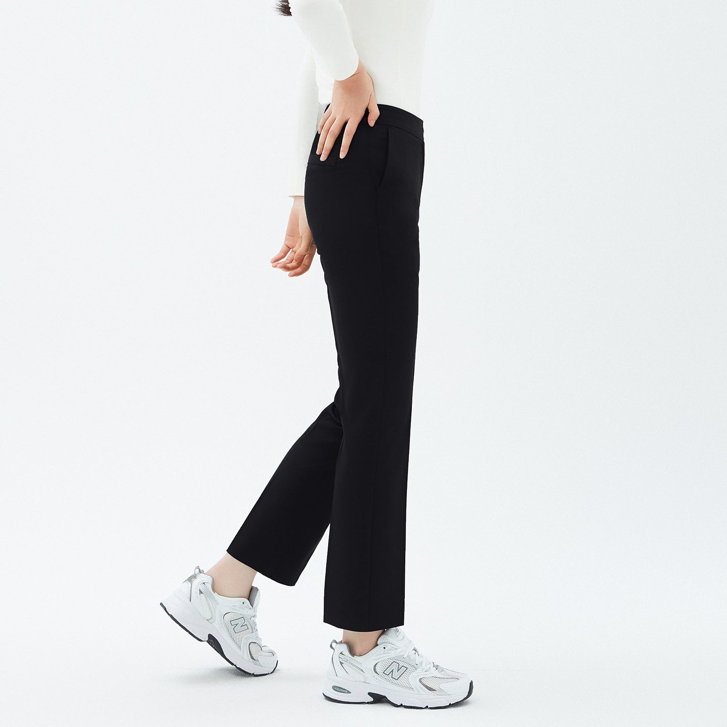 Side angle of TUL Women's Comfort Banding Pants in Stretch Black, highlighting a smooth waistband and sleek silhouette.