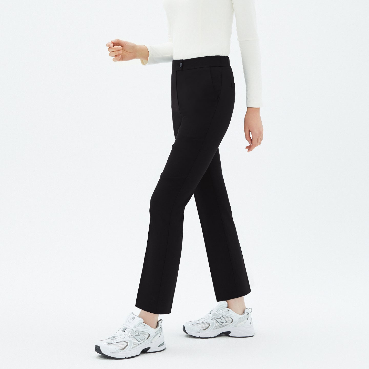 Model walking in TUL Women's Comfort Banding Pants in Stretch Black, emphasizing a straight-leg cut and comfortable stretch fabric.