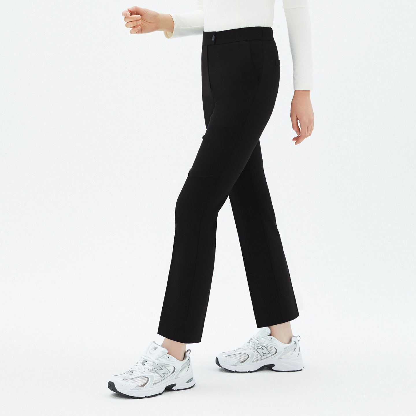 Image of Model walking in TUL Women's Comfort Banding Pants in Stretch Black, emphasizing a straight-leg cut and comfortable stretch fabric.