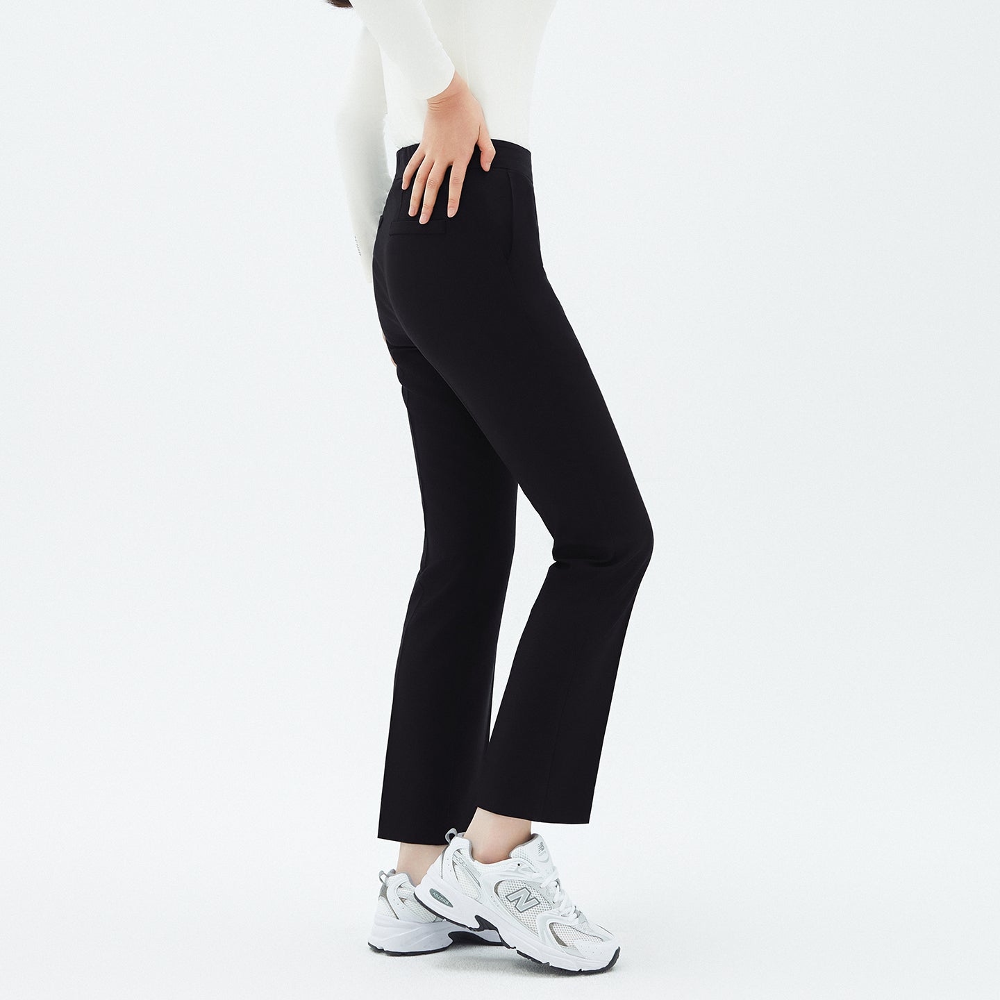 Close-up side view of TUL Women's Comfort Banding Pants in Stretch Black, showcasing the tailored fit and flexible waistband.