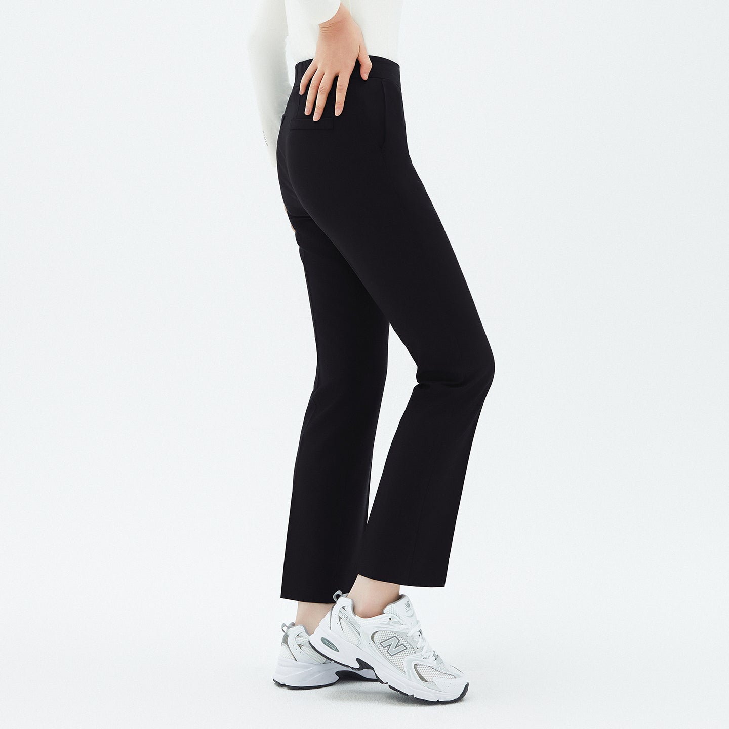 Image of Close-up side view of TUL Women's Comfort Banding Pants in Stretch Black, showcasing the tailored fit and flexible waistband.