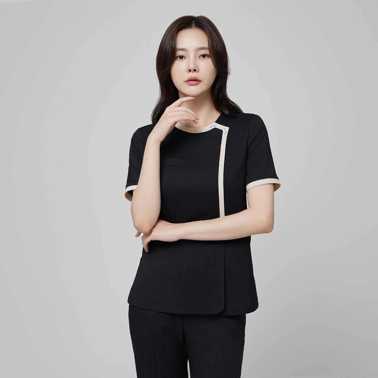 Front view of TUL NS-175 Women’s Check Beige Round Collar Scrub Top in Stretch Black, showcasing subtle beige accents and a modern round collar.