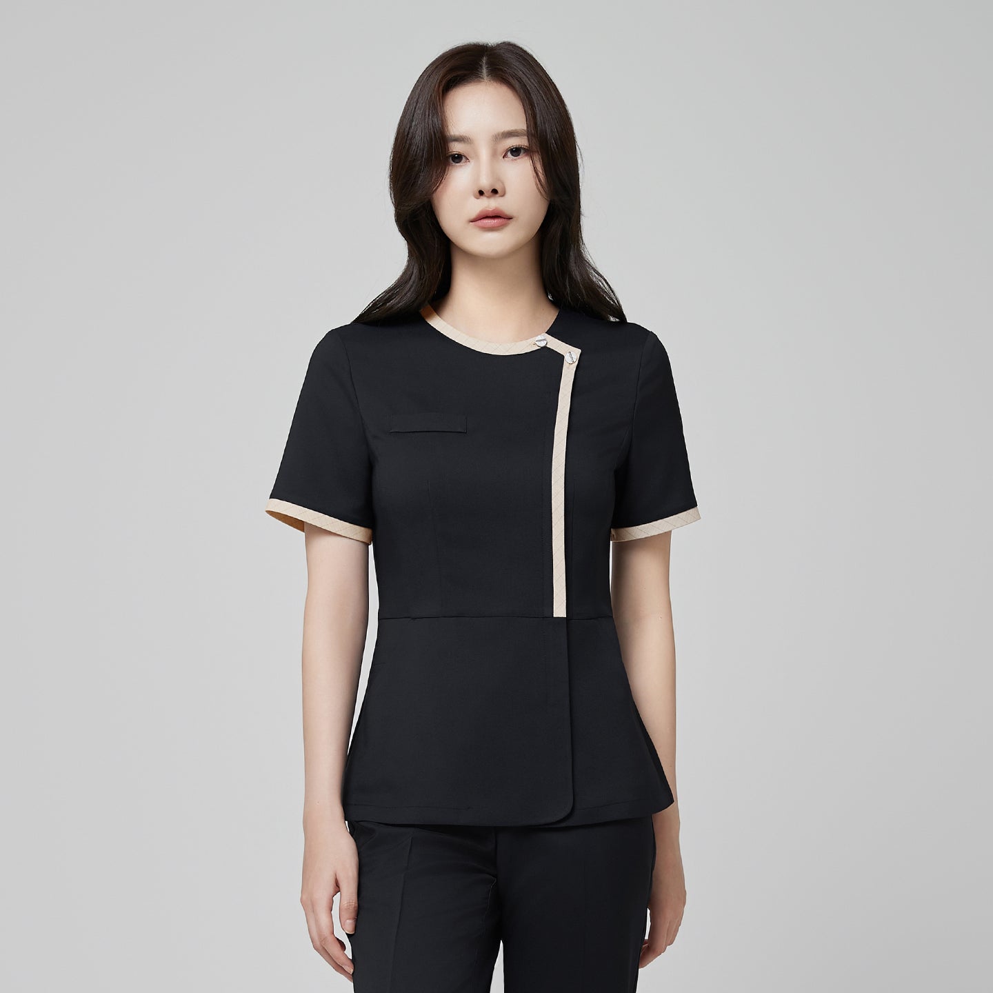 Close-up of TUL NS-175 Women’s Check Beige Round Collar Scrub Top in Stretch Black, emphasizing the contrasting beige trim and professional silhouette.