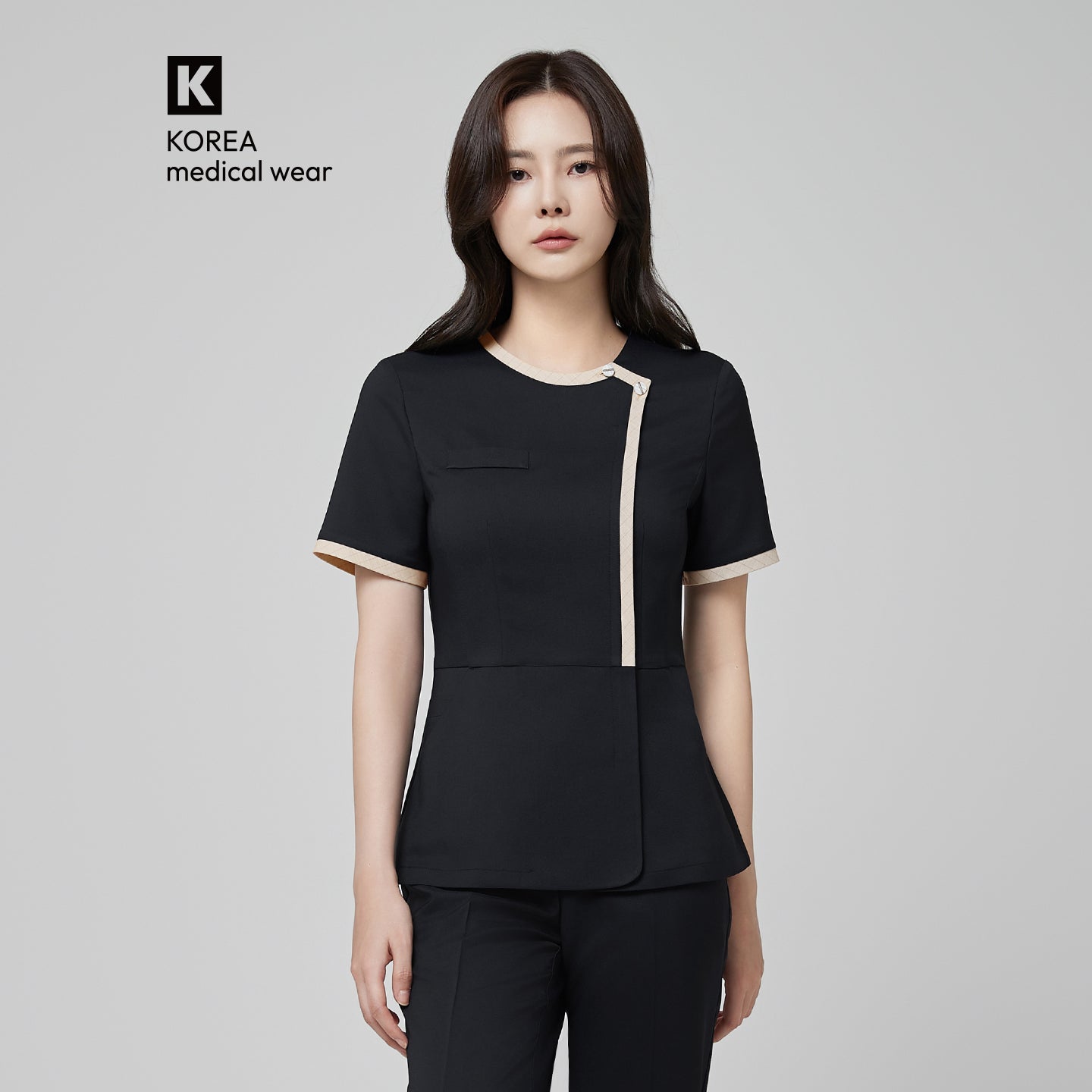 Image of Close-up of TUL NS-175 Women’s Check Beige Round Collar Scrub Top in Stretch Black, emphasizing the contrasting beige trim and professional silhouette.
