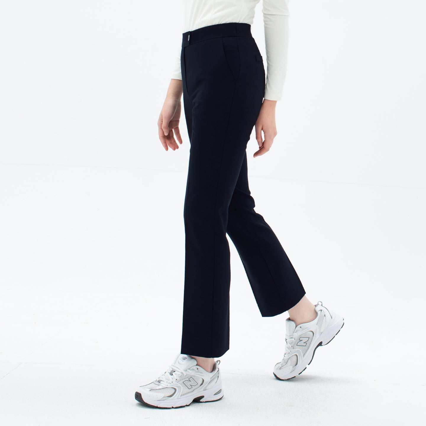 Image of Model wearing TUL Women's Comfort Banding Pants in Stretch Navy, emphasizing the flattering straight-leg silhouette and breathable material.