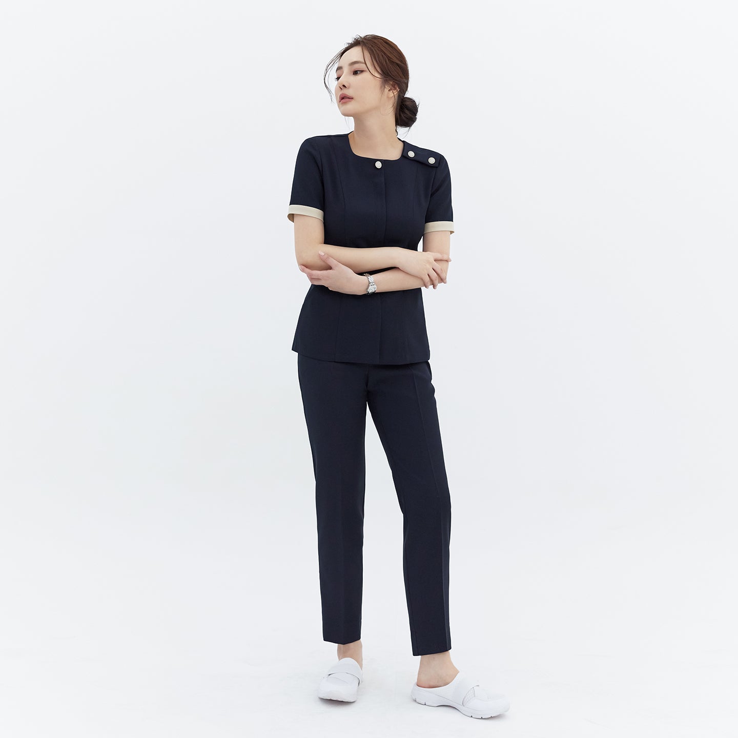 Full-length shot of TUL NCS-01 Women’s Classic Accent Scrub Top in Stretch Navy, paired with matching pants for a cohesive, professional look.