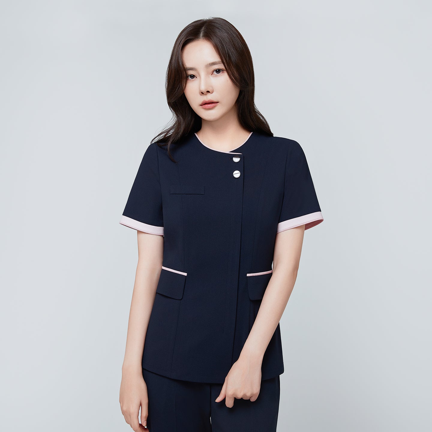 Image of Front view of TUL NCS-04 Women’s Blush Edge Scrub Top in Stretch Navy, highlighting pink accent trim on the sleeves and collar.