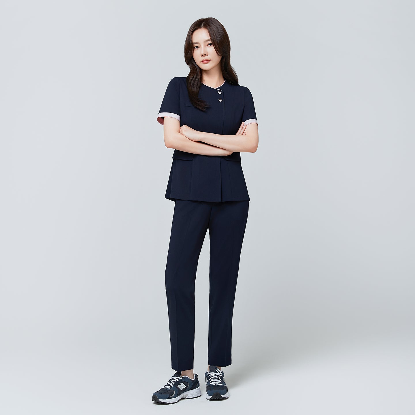 Full-length view of TUL NCS-04 Women’s Blush Edge Scrub Top in Stretch Navy, paired with matching pants for a cohesive uniform.
