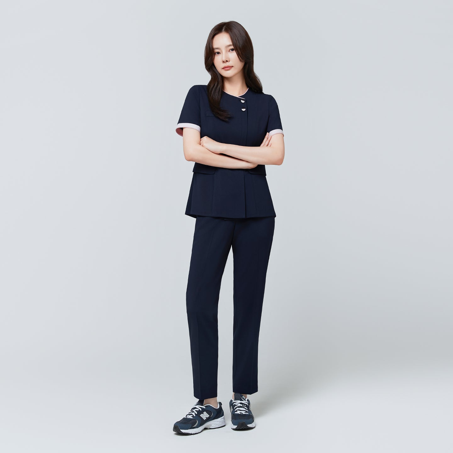 Image of Full-length view of TUL NCS-04 Women’s Blush Edge Scrub Top in Stretch Navy, paired with matching pants for a cohesive uniform.