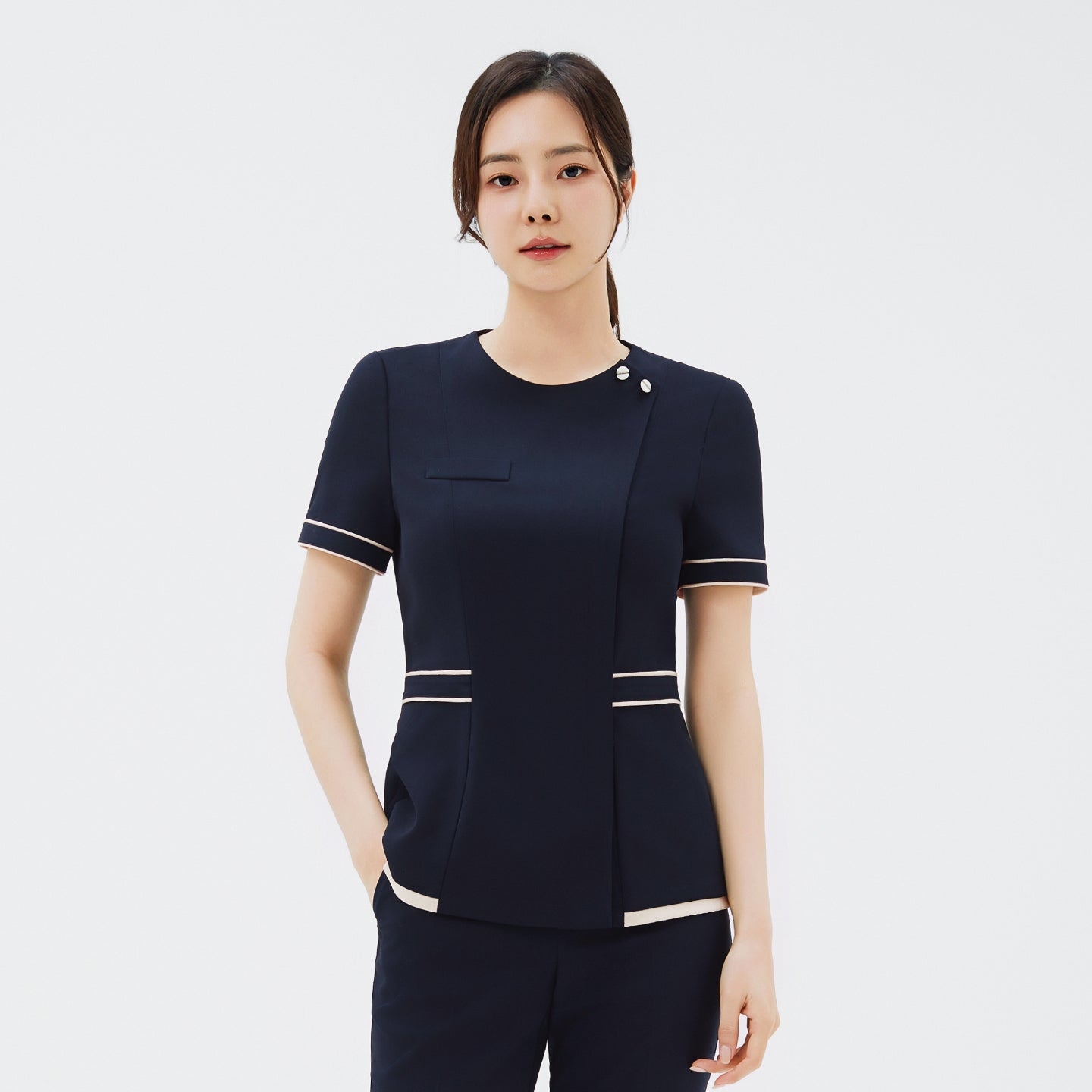 Image of Front view of TUL NCS-07 Women's Ivory Dual Tone Scrub Top in Stretch Navy, highlighting subtle snap button details near the collar.