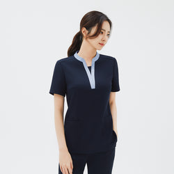 Image of Side angle of TUL NS-179 V-Stretch Color Scrub Top in Stretch Navy, showcasing a stylish V-neck trim and practical pockets.