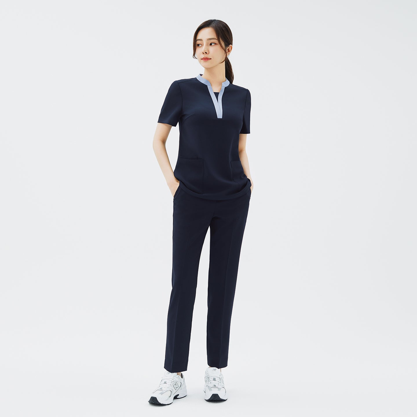Full-length shot of TUL NS-179 Women's V-Stretch Color Scrub Top in Stretch Navy, paired with matching pants for a cohesive uniform look.