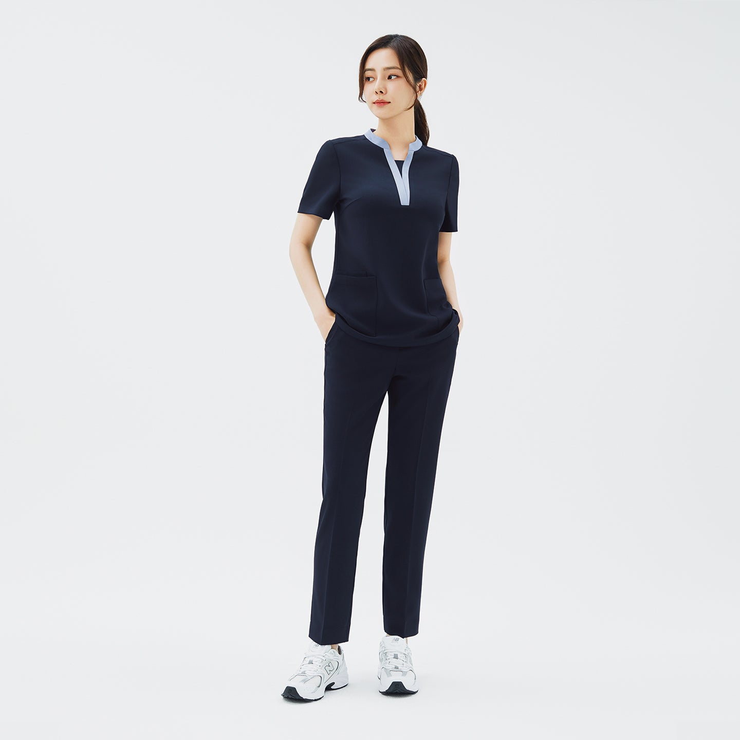 Image of Full-length shot of TUL NS-179 Women's V-Stretch Color Scrub Top in Stretch Navy, paired with matching pants for a cohesive uniform look.