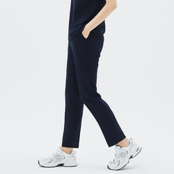 Image of Model walking in TUL Women's Style Pants in Stretch Navy, emphasizing a comfortable, tapered fit and durable stretch material.