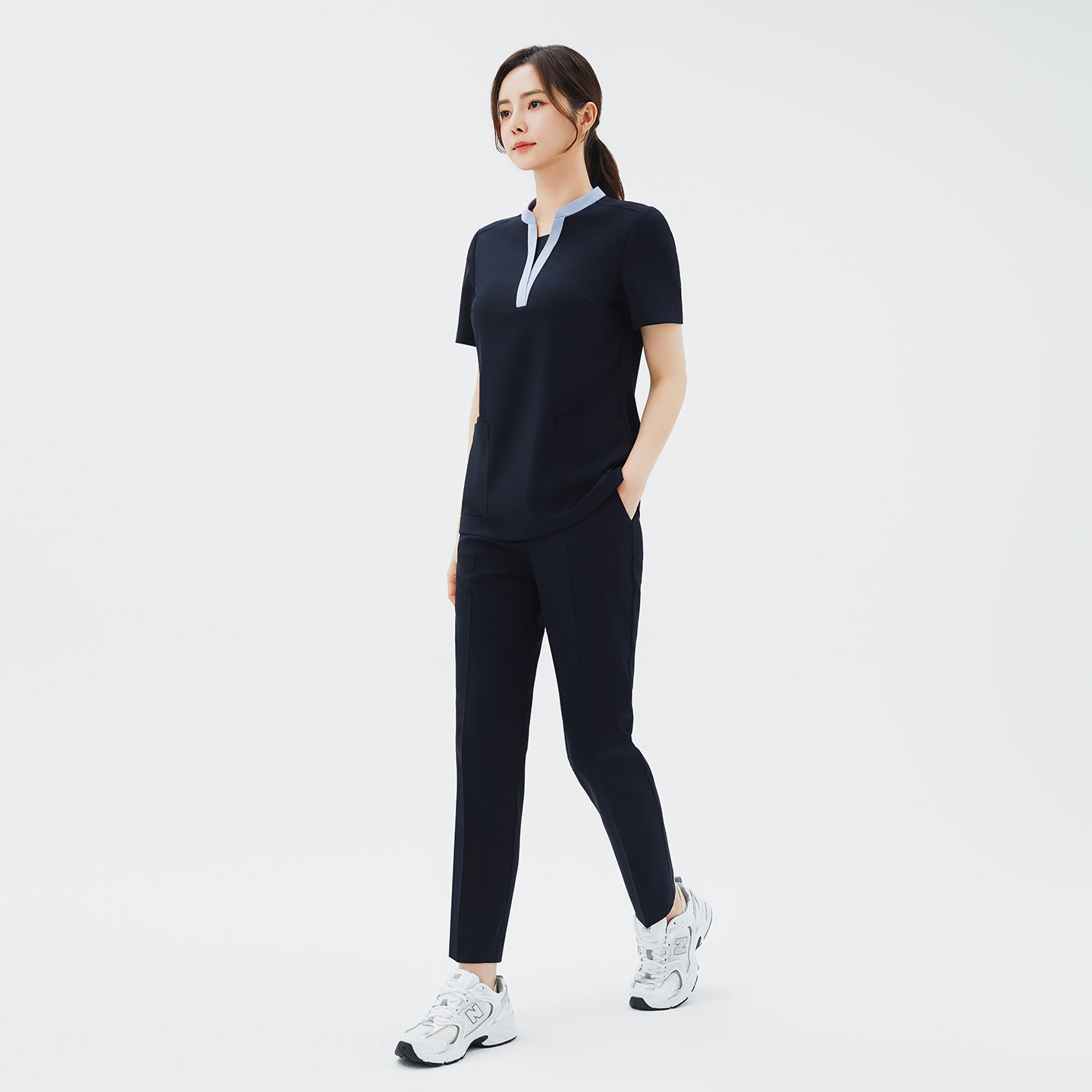 Side angle of TUL Women's Style Pants in Stretch Navy, showcasing the flexible fabric and sleek seam details.