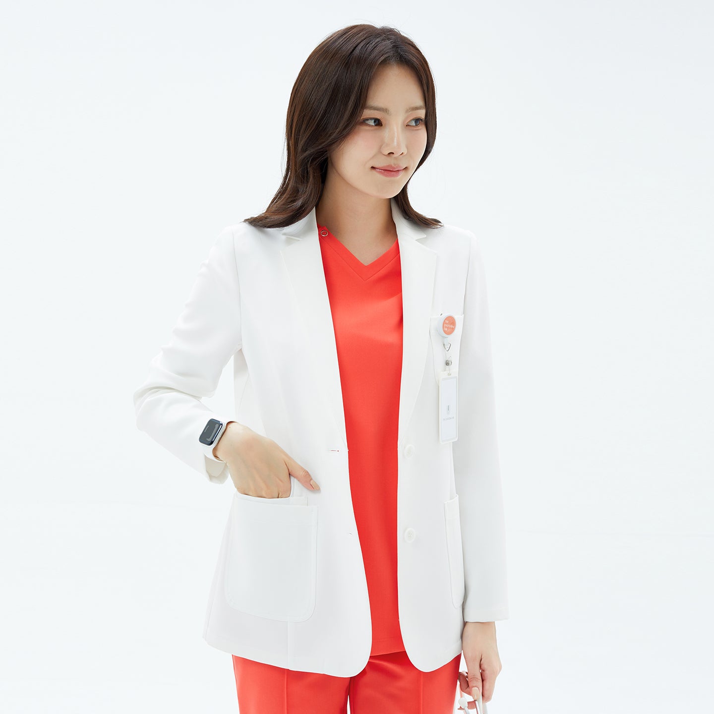 Image of Close-up side pose of the TUL Women's LCW-16 Prime Short Lab Coat - White Ivory, with the model’s hand in the front pocket.