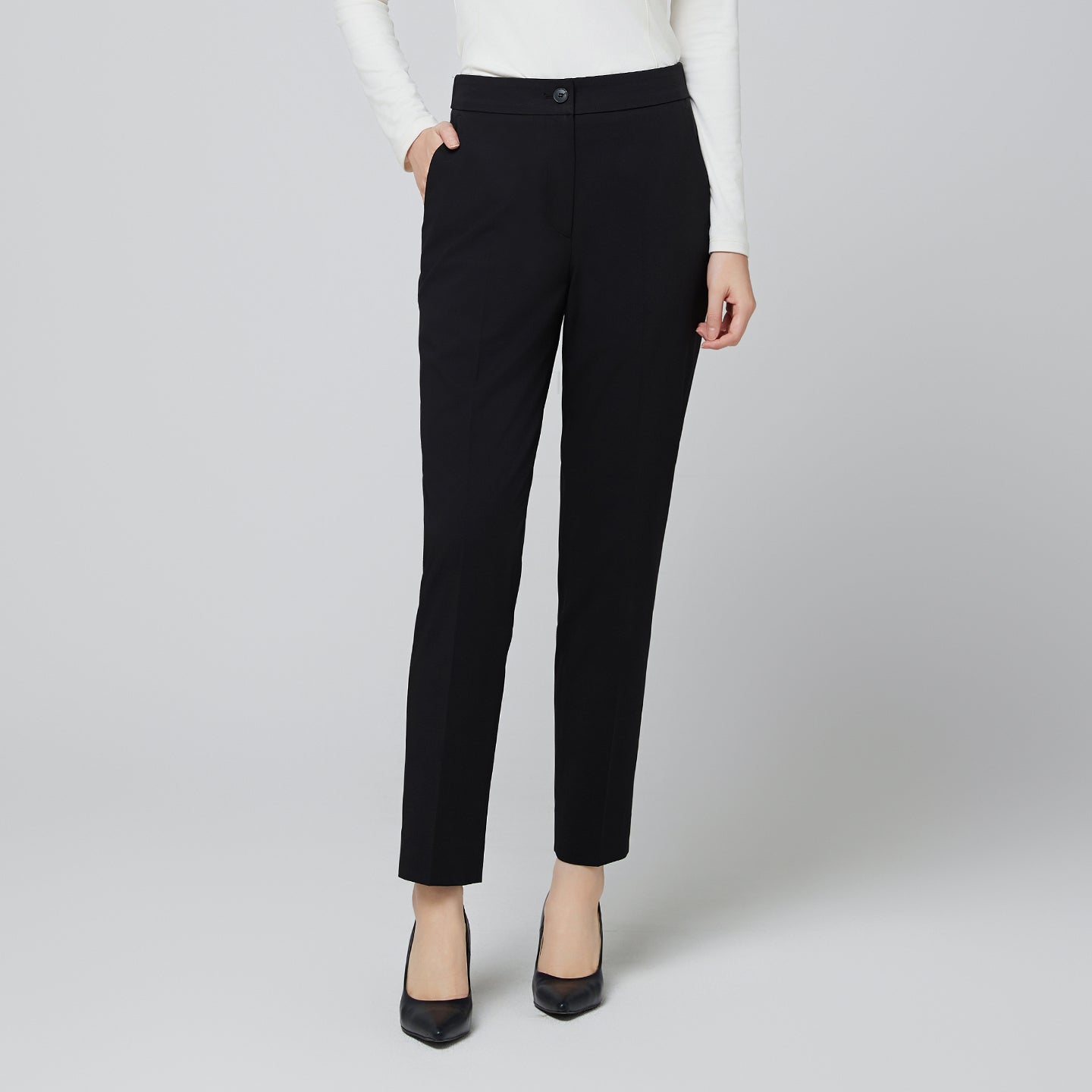 Image of Detail shot of the waistband on TUL Women's CS Straight Banding Pants in YT Black, focusing on the smooth, comfortable elastic band and the refined finish of the fabric.