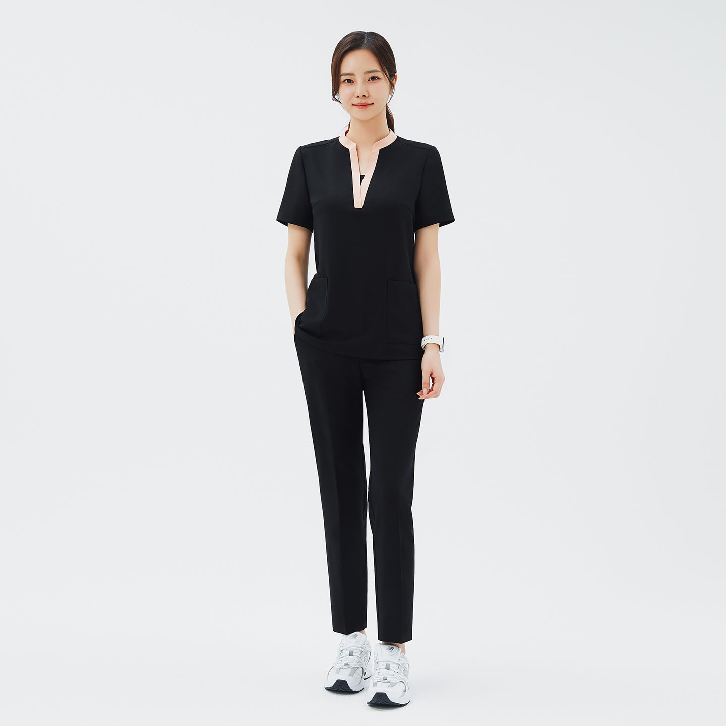 Full-length shot of TUL Women's CS Straight Banding Pants in YT Black worn by a model, paired with a matching scrub top; the image highlights the smooth fabric, comfortable waistband, and tailored silhouette.