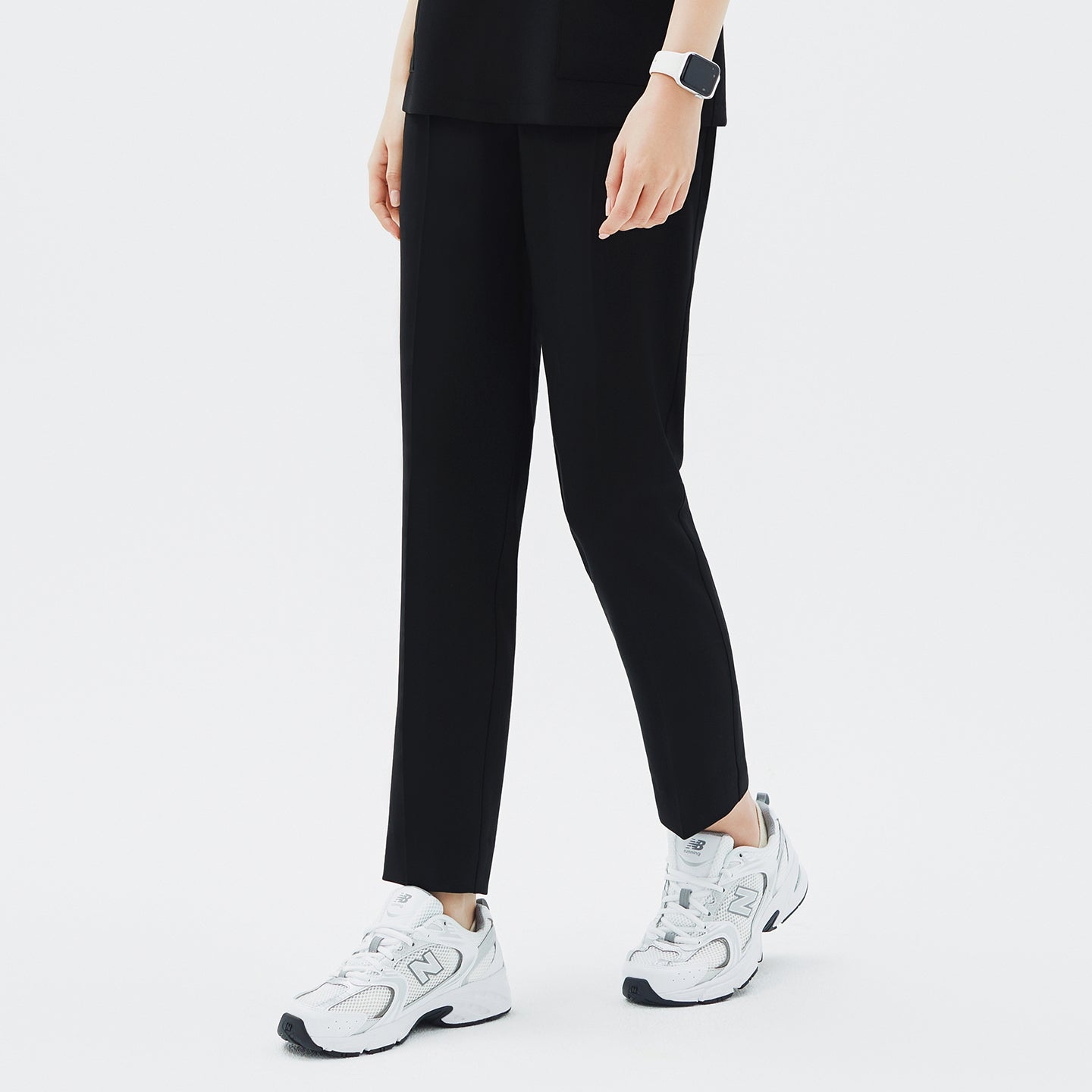 Image of Side angle of TUL Women's CS Straight Banding Pants in YT Black on a model, emphasizing the streamlined leg cut, fabric drape, and precise stitching along the side seams.