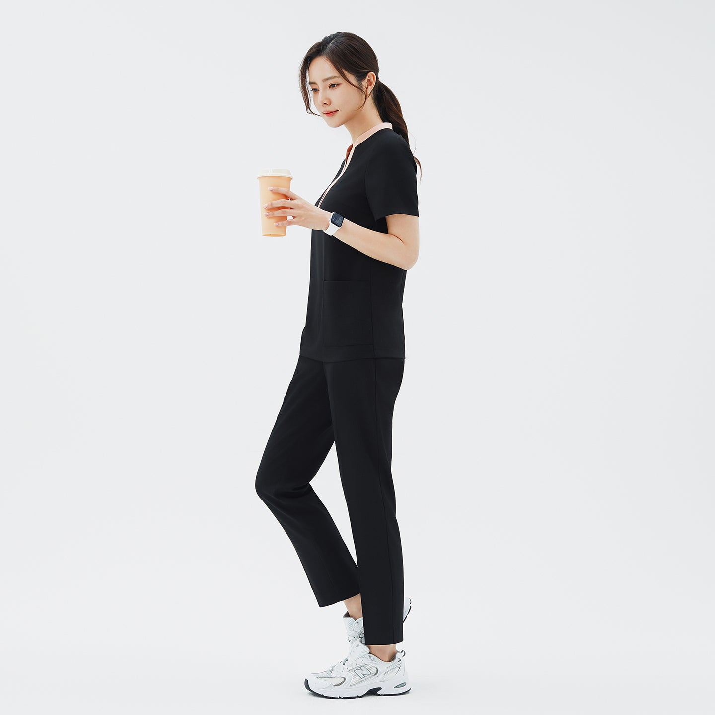 Side angle of TUL Women's CS Straight Banding Pants in YT Black on a model, emphasizing the streamlined leg cut, fabric drape, and precise stitching along the side seams.