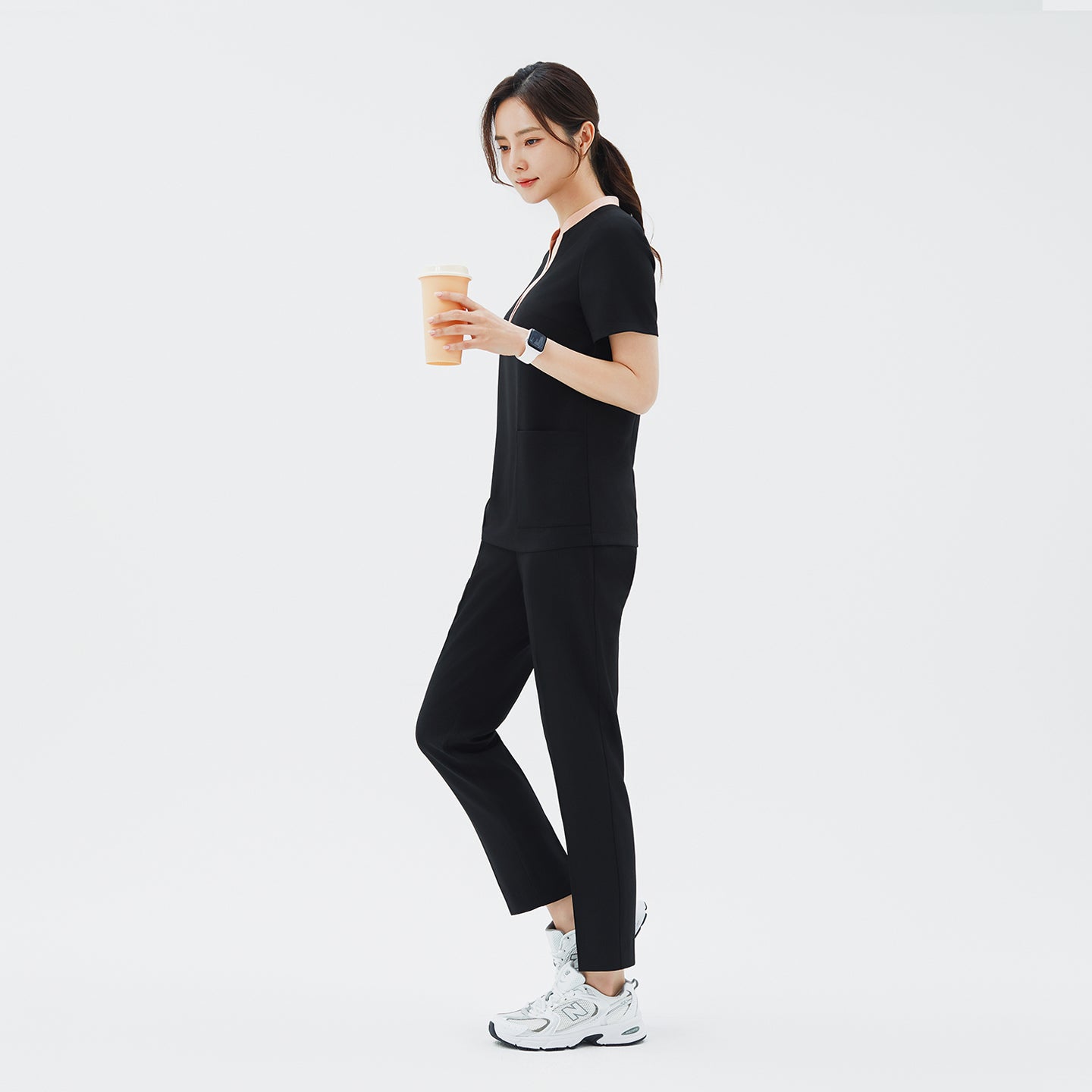 Image of Side angle of TUL Women's CS Straight Banding Pants in YT Black on a model, emphasizing the streamlined leg cut, fabric drape, and precise stitching along the side seams.