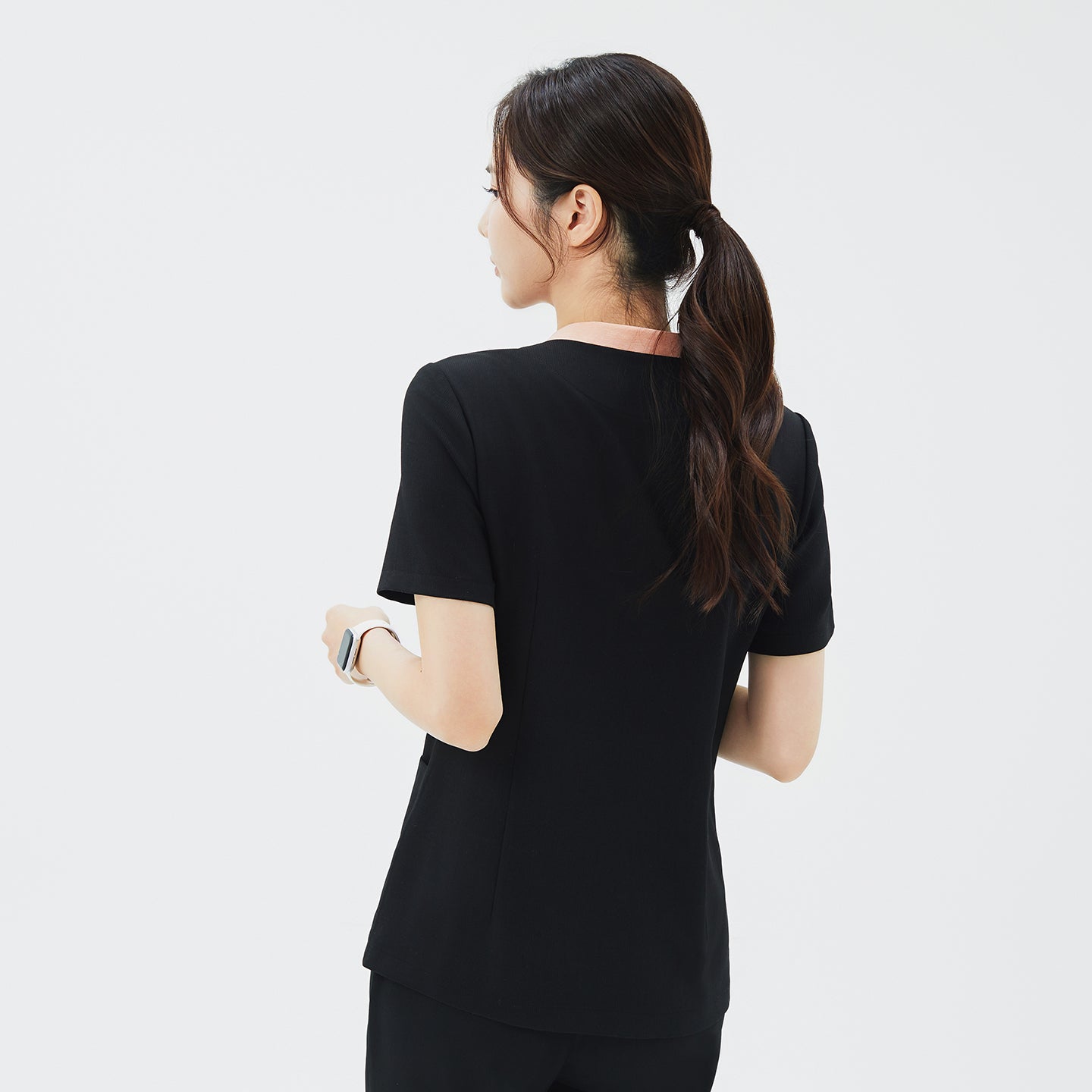 Image of Back view of TUL NS-178 Women's V-Stretch Color Scrub Top in YT Black, emphasizing structured seams, a crisp neckline with subtle color detail, and a comfortable, professional silhouette.