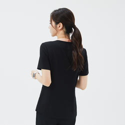 Image of Back view of TUL NS-178 Women's V-Stretch Color Scrub Top in YT Black, emphasizing structured seams, a crisp neckline with subtle color detail, and a comfortable, professional silhouette.