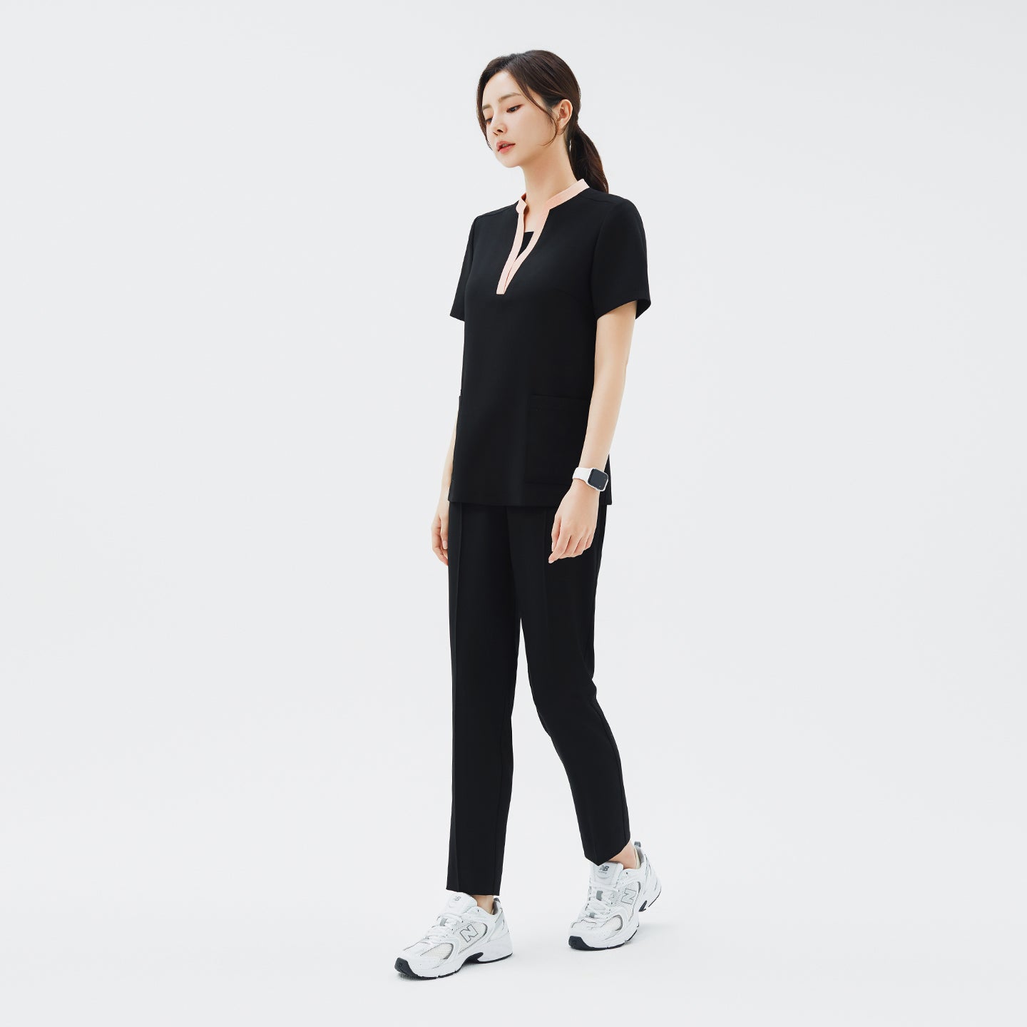 Image of Side view of TUL NS-178 Women's V-Stretch Color Scrub Top in YT Black, showcasing a tailored fit, flexible stretch material, and contemporary design details that enhance its professional look in clinical settings.