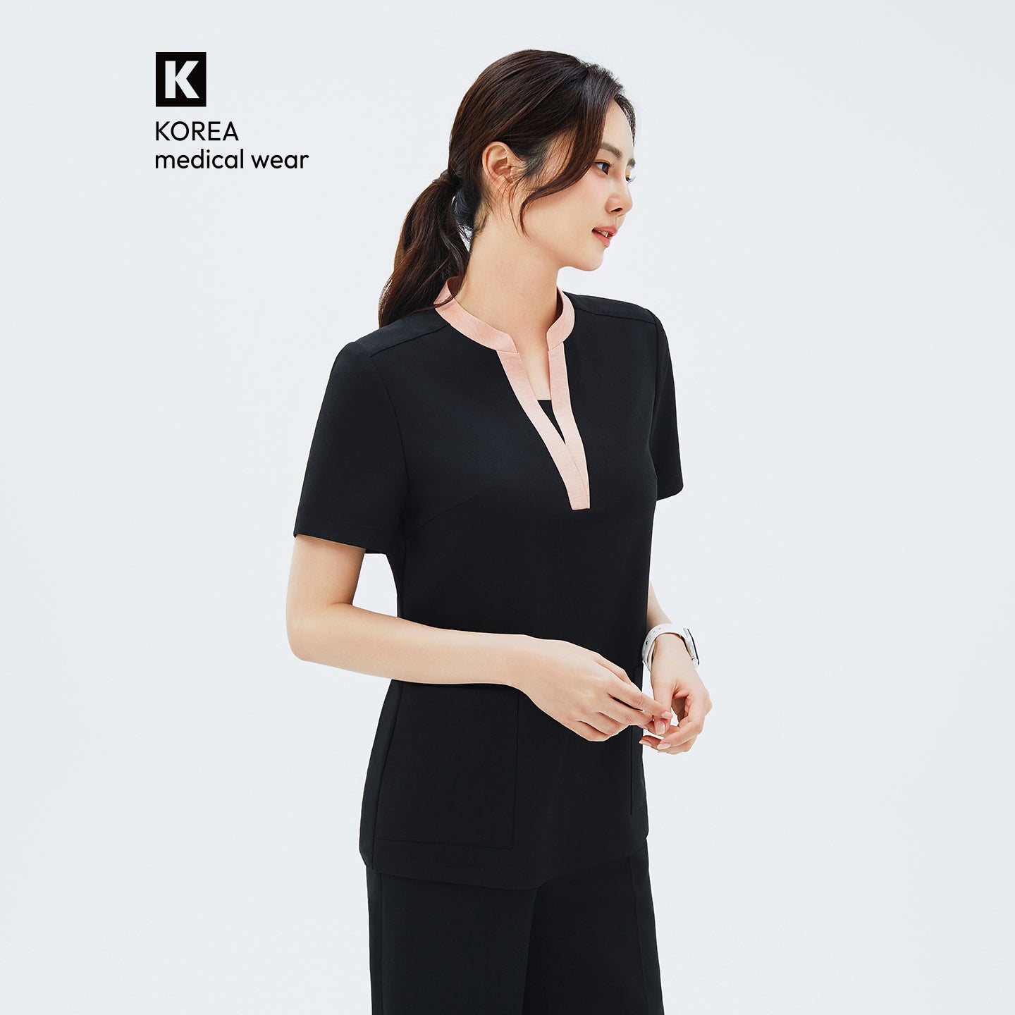 Image of Side angle of TUL NS-178 Women's V-Stretch Color Scrub Top in YT Black, highlighting the tailored fit, draped sleeve edges, and the modern stretch fabric design.